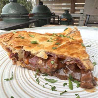  Steak and Ale Pie: Uma explosão saborosa de carne suculenta em um molho encorpado, embebido em uma crosta de torta leve e amanteigada!